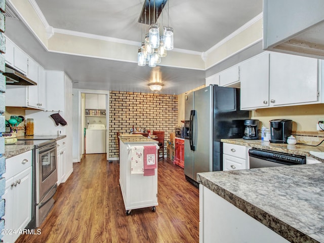 kitchen with white cabinetry, stainless steel appliances, dark wood-type flooring, pendant lighting, and washer / dryer