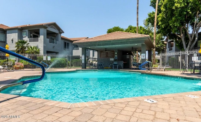 community pool with a gazebo, a patio area, fence, and a ceiling fan