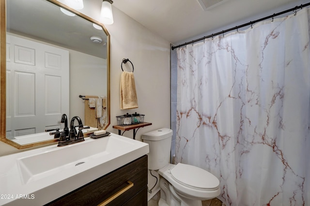 bathroom featuring vanity, toilet, and a shower with shower curtain