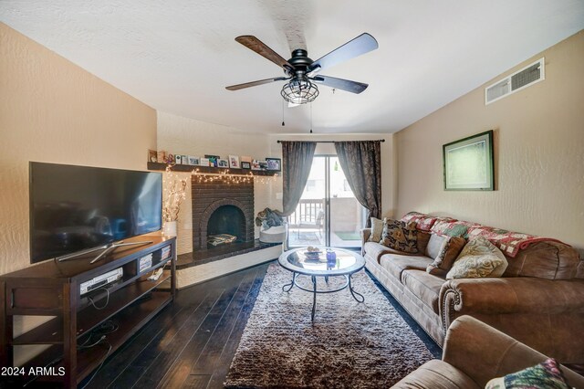 living room featuring ceiling fan, a brick fireplace, and hardwood / wood-style floors