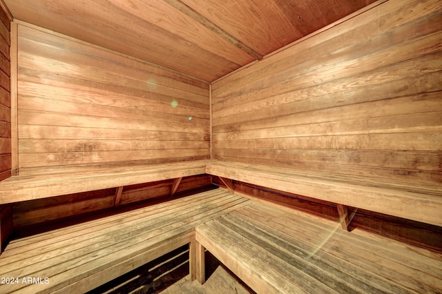 view of sauna / steam room featuring wood walls and wooden ceiling