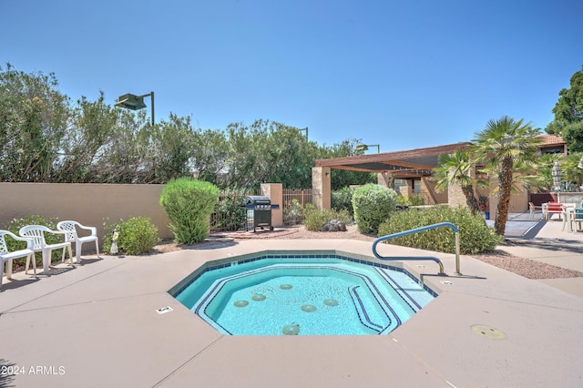 view of pool with a hot tub, area for grilling, and a patio area