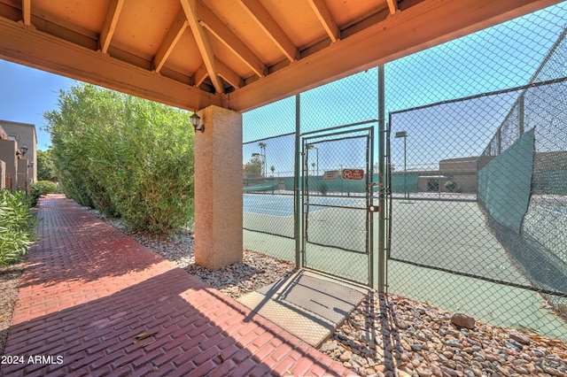 exterior space with tennis court