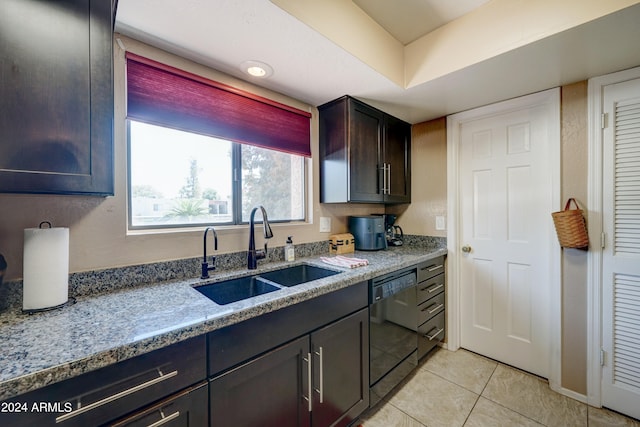 kitchen featuring black dishwasher, dark brown cabinets, sink, light stone counters, and light tile patterned floors