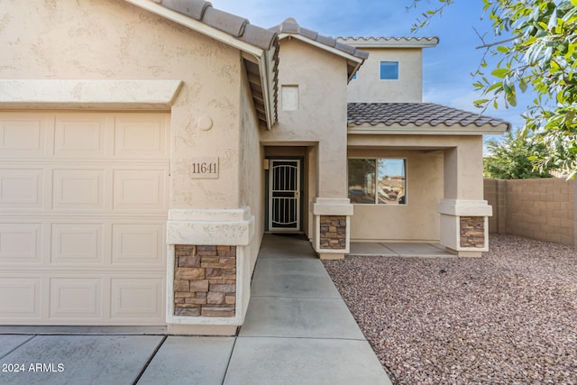 doorway to property with a garage