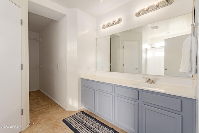 bathroom with tile patterned flooring and vanity