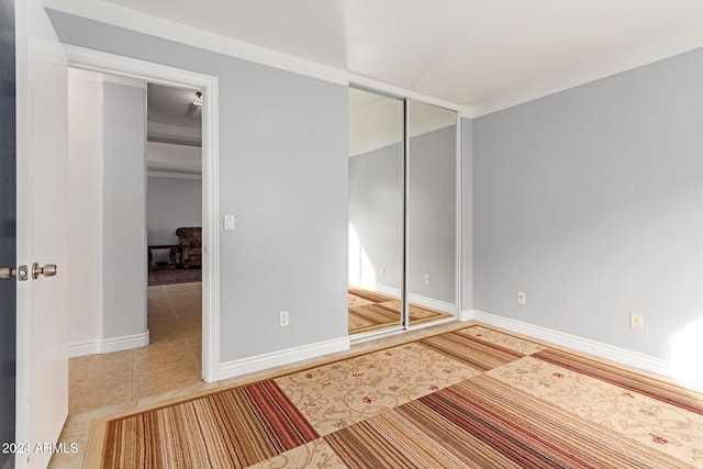 unfurnished bedroom featuring a closet and tile patterned flooring