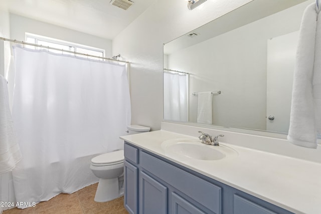 full bathroom featuring tile patterned flooring, vanity, toilet, and shower / tub combo with curtain