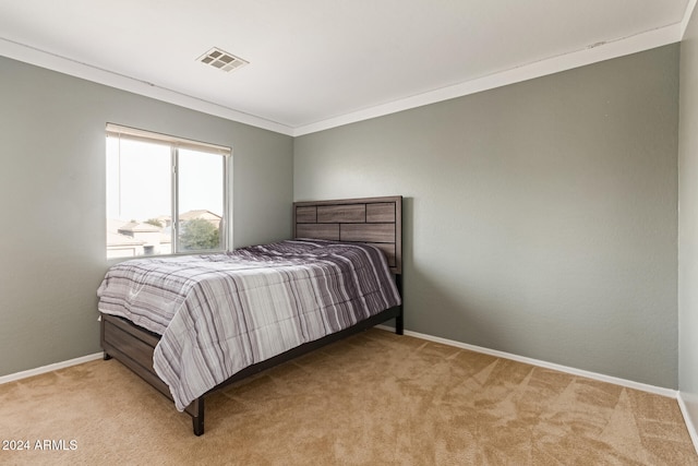 bedroom featuring ornamental molding and light carpet