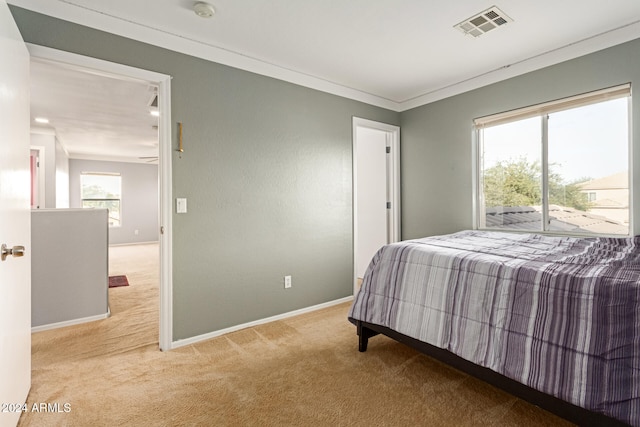 carpeted bedroom featuring crown molding