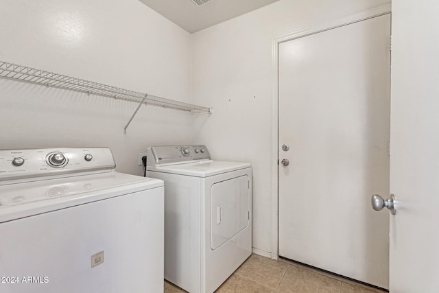 laundry area featuring independent washer and dryer and light tile patterned floors