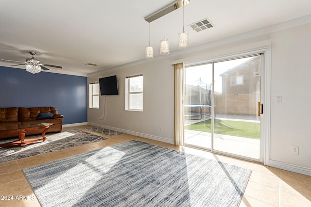 unfurnished living room featuring tile patterned floors and ceiling fan