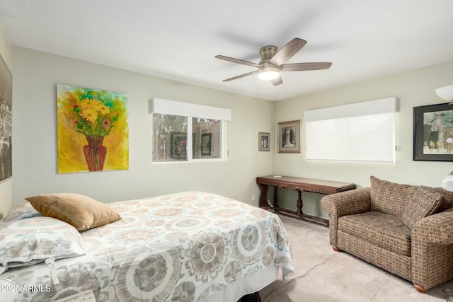 bedroom featuring multiple windows, carpet flooring, and a ceiling fan