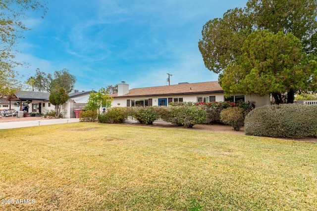 ranch-style house featuring a front lawn