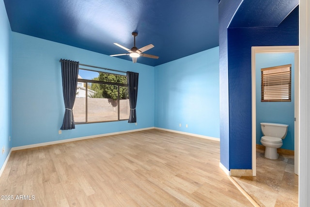 empty room with hardwood / wood-style floors and ceiling fan