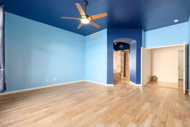 unfurnished room with light hardwood / wood-style flooring, ceiling fan, and vaulted ceiling