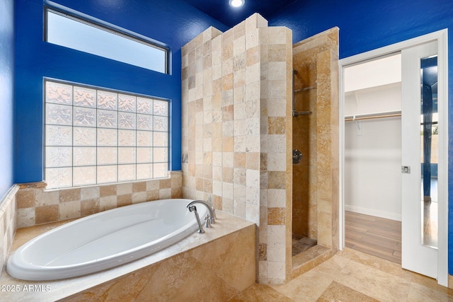 bathroom with a healthy amount of sunlight and plus walk in shower