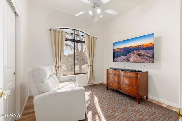 sitting room with ceiling fan and hardwood / wood-style floors