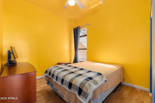 bedroom with wood-type flooring and ceiling fan