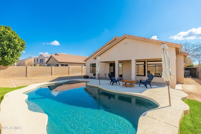 view of pool with cooling unit and a patio area