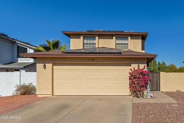 view of front of house featuring a garage and solar panels