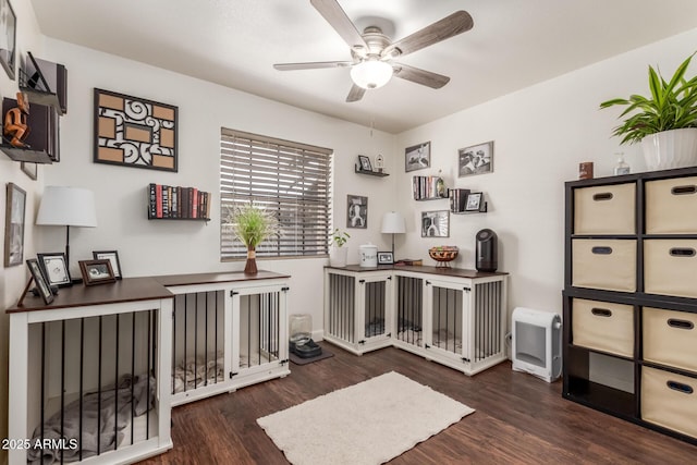 office area with dark wood-type flooring and ceiling fan