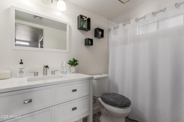 bathroom with vanity, toilet, and a shower with shower curtain