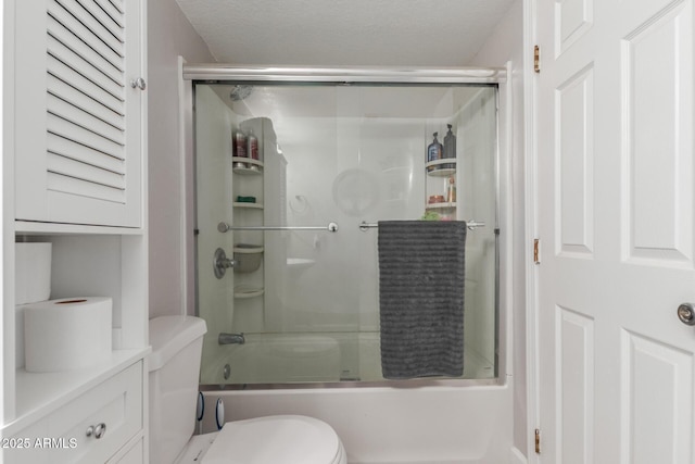 full bathroom featuring bath / shower combo with glass door, a textured ceiling, toilet, and vanity