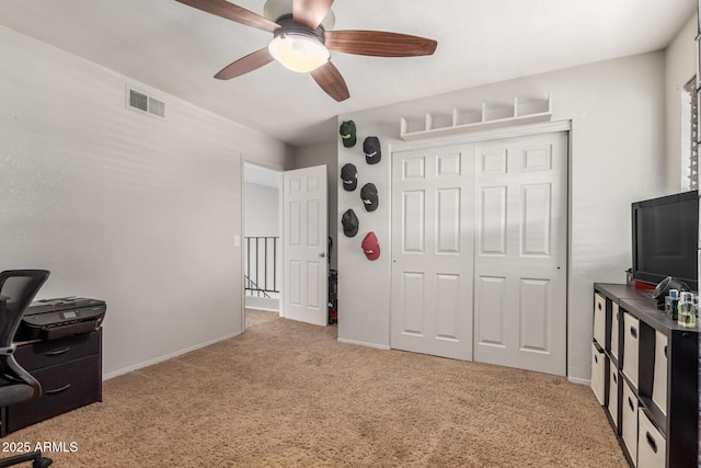 office featuring ceiling fan and light carpet