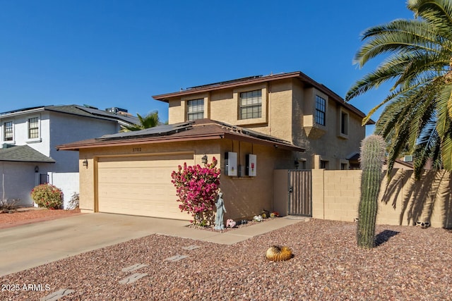 view of front of property with a garage and solar panels