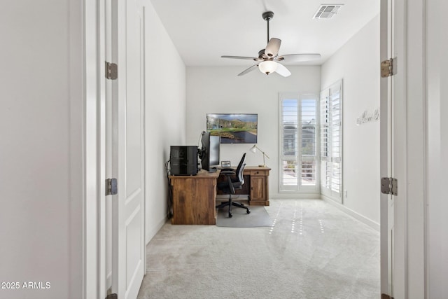 carpeted office space featuring baseboards, visible vents, and a ceiling fan