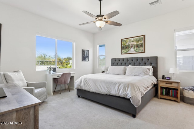 bedroom featuring ceiling fan, visible vents, and light colored carpet