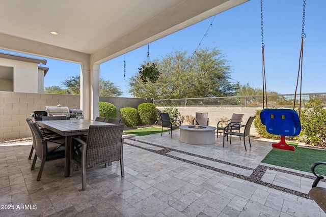 view of patio / terrace featuring an outdoor fire pit, outdoor dining area, and a fenced backyard