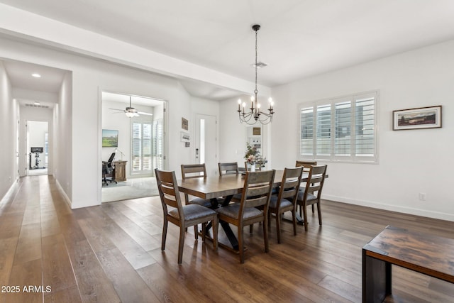 dining area featuring a notable chandelier, dark wood-style flooring, and baseboards