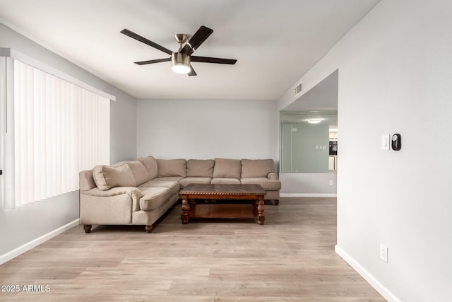 living room featuring ceiling fan and light hardwood / wood-style flooring