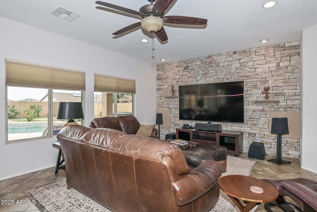 living room featuring a fireplace and ceiling fan