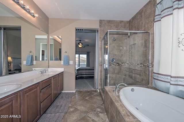 bathroom with vanity and shower with separate bathtub