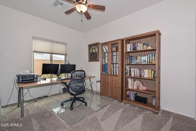 carpeted office featuring ceiling fan