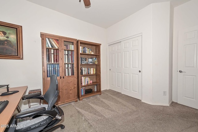 carpeted office space with ceiling fan