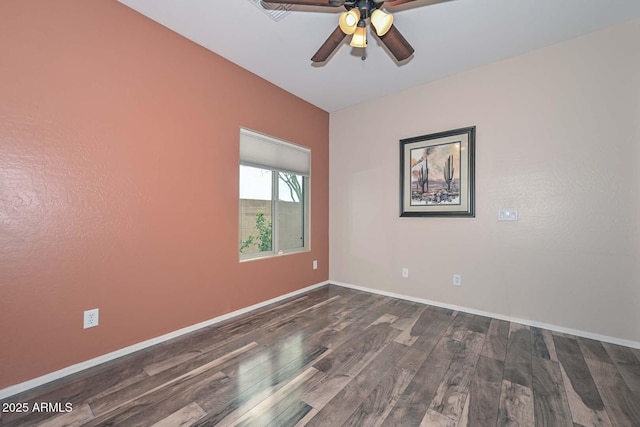 empty room featuring dark hardwood / wood-style flooring and ceiling fan