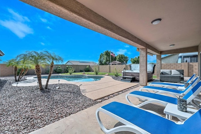 view of patio featuring a swimming pool with hot tub and outdoor lounge area