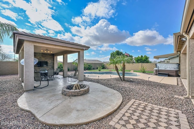 view of patio featuring a pool with hot tub and a fire pit