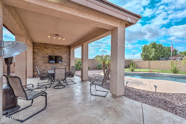 view of patio with a fenced in pool