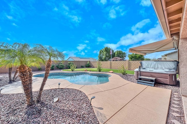 view of swimming pool featuring a patio area and a hot tub