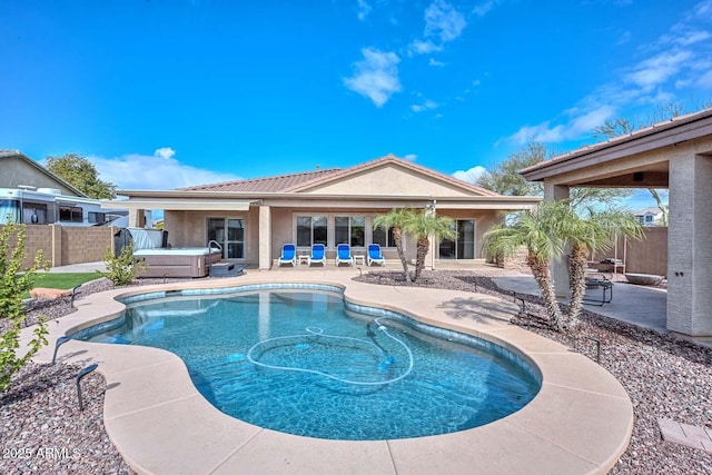 view of pool featuring a hot tub and a patio area