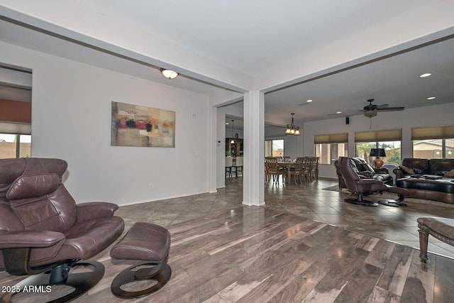 living room with dark hardwood / wood-style floors and a notable chandelier