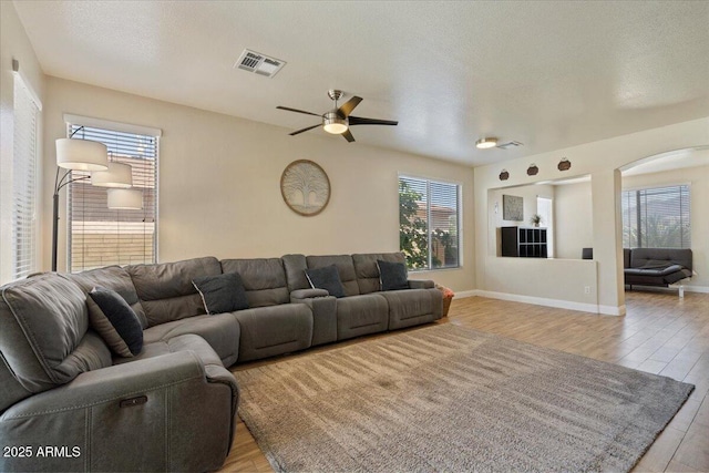 384 N Scott Dr, Chandler, AZ 85225 - living area featuring arched walkways, a ceiling fan, light wood-style floors, and visible vents