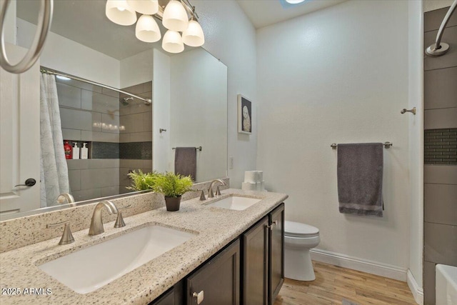 384 N Scott Dr, Chandler, AZ 85225 - bathroom with wood finished floors, toilet, baseboards, and a sink