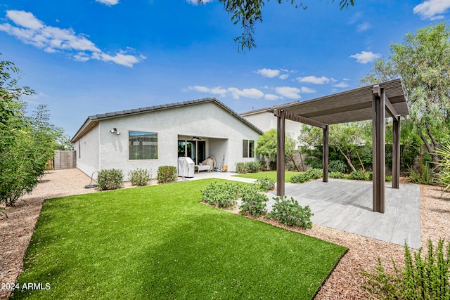 rear view of property featuring a patio and a yard