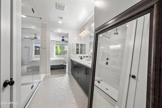 bathroom featuring a shower with shower door, vanity, tile patterned floors, and ceiling fan